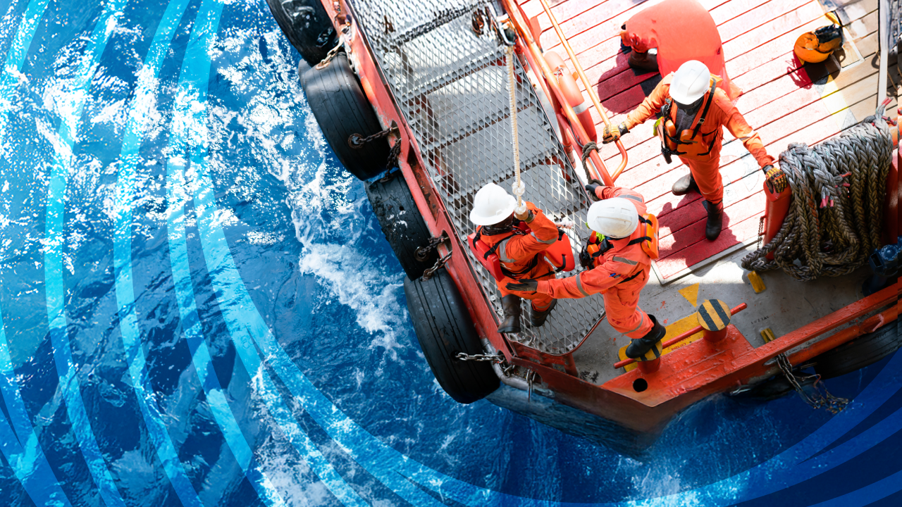 Day of the Seafarer 2025 - My Harassment-Free Ship. Image of cargo ship from above, man in orange jumpsuit working on the ship.